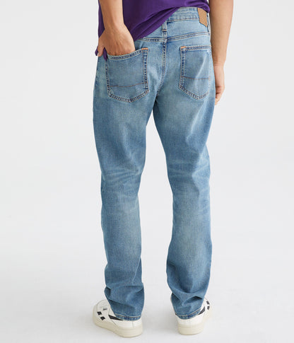 Person wearing light blue jeans on a white background