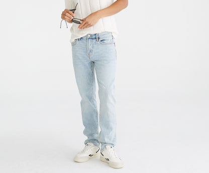 Person wearing a white polo shirt and light blue jeans on a white background