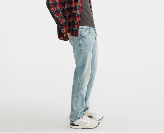 Person wearing a plaid shirt and jeans on a white background